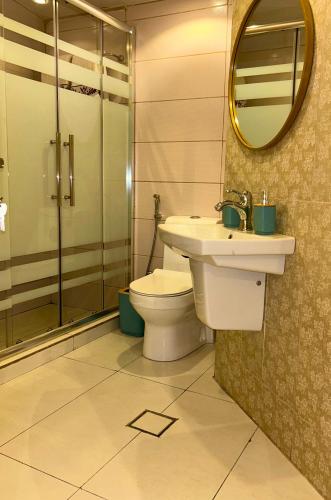a bathroom with a toilet and a sink and a mirror at Celestia Boutique Inn - Boutique Stay Overlooking Jerash Ruins in Jerash