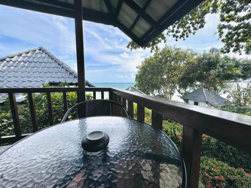 a table on a balcony with a view of the ocean at Lamai Bayview Boutique Resort in Lamai