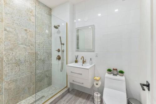 a bathroom with a shower and a toilet and a sink at Studio w Charming Juliet Balcony in Upper East in New York