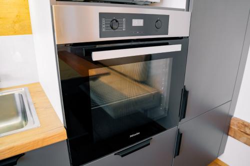a microwave oven in a kitchen next to a counter at Kiechlhof in Patsch