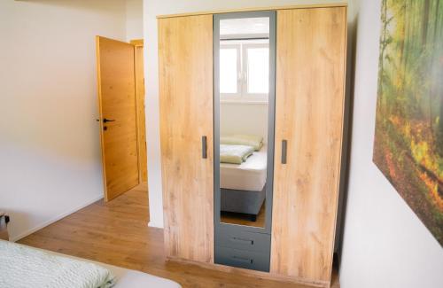 a mirror in a room with a bed at Kiechlhof in Patsch