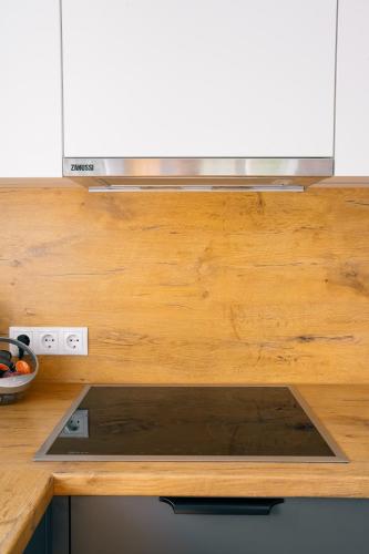 a kitchen with a wooden counter top with a stove at Kiechlhof in Patsch