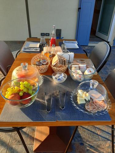 a table with bowls and plates of food on it at Bed and Breakfast Cà Tognella in Pescantina