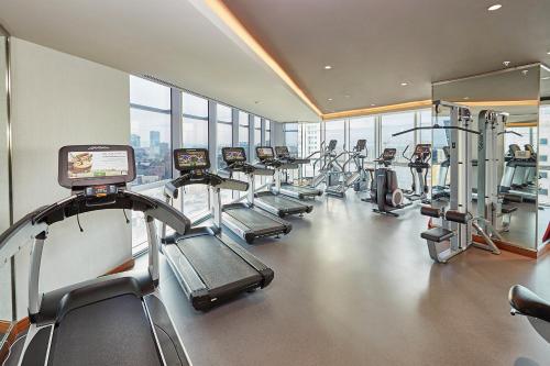a gym with a row of treadmills and machines at Wyndham Grand Istanbul Levent Hotel & Conference Center in Istanbul