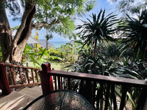 a balcony with a bench and a view of the ocean at Lamai Bayview Boutique Resort in Lamai