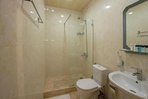 a bathroom with a shower and a toilet and a sink at Hotel Season in Yerevan