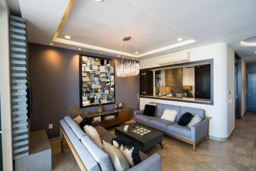 a living room with a couch and a table at Pinnacle Resorts 180 in Puerto Vallarta