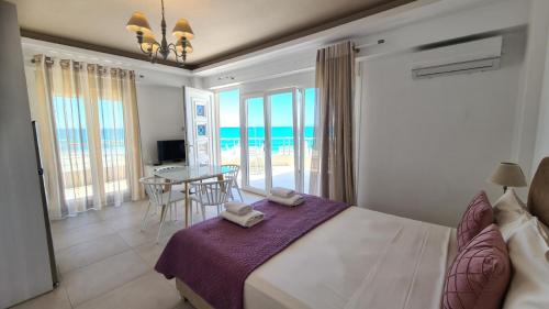 a bedroom with a bed with a view of the ocean at Bella Mare Luxury Apartments in Kalamaki Heraklion