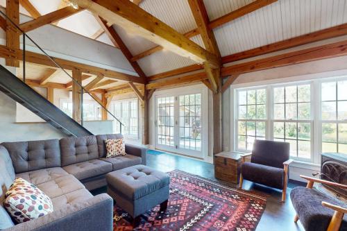 a living room with a couch and chairs and windows at Cider Hill Haven in New Haven