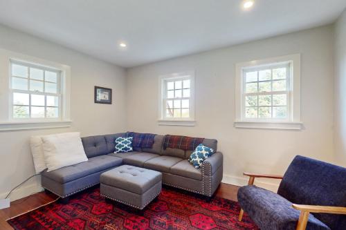 a living room with a couch and two chairs at Cider Hill Haven in New Haven