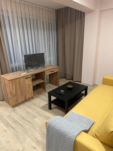 a living room with a tv and a couch and a table at NIKA The architect DIAMOND OF GEVGELIA in Gevgelija