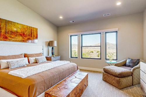 a bedroom with a large bed and a chair at Lakeside Luxury in Heber City