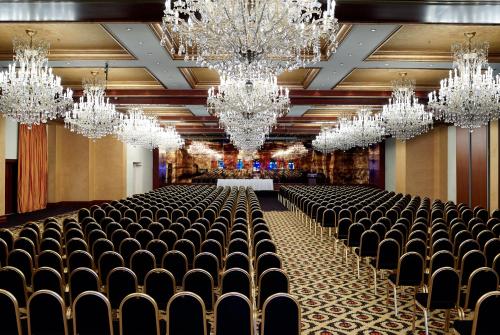 a large room with chandeliers and chairs in it at Grand Serai Congress and Spa in Ioannina