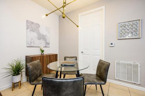 a dining room with a glass table and chairs at Vista Cay Resort by Millenium at Universal Blvd. in Orlando