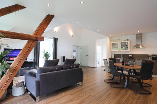 a living room with a couch and a table at Ferienloft Lippe in Lage