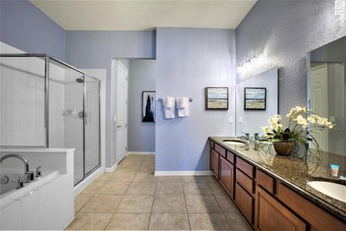 a bathroom with two sinks and a shower at Vista Cay Resort by Millenium at Universal Blvd. in Orlando