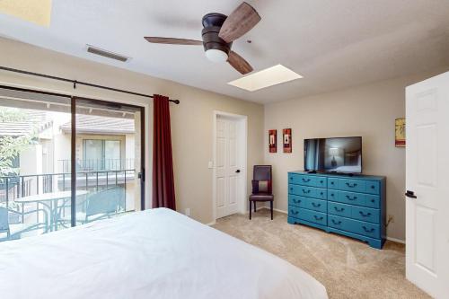 a bedroom with a bed and a tv and a window at Canyon Mesa Retreat in Sedona