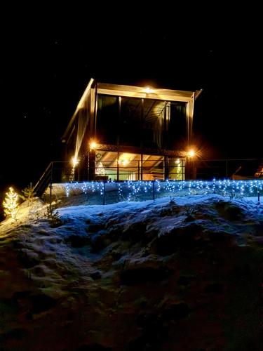 a building lit up at night with lights at Gzaze in Stepantsminda
