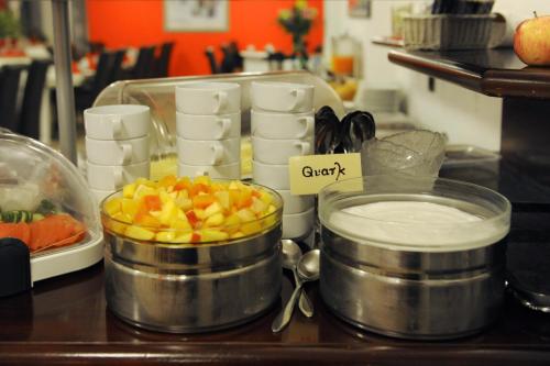 a counter with two pots of food on a table at Bellevue Hotel in Düsseldorf