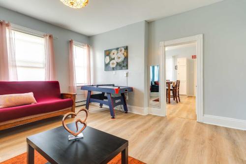 a living room with a red couch and a table at Charming Stoughton Apartment 20 Mi to Boston in Stoughton