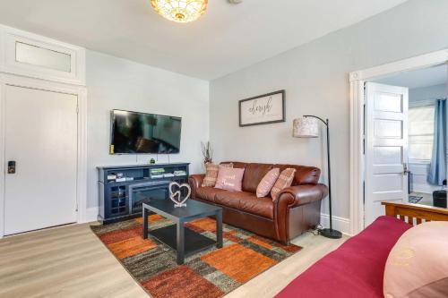 a living room with a leather couch and a tv at Charming Stoughton Apartment 20 Mi to Boston in Stoughton