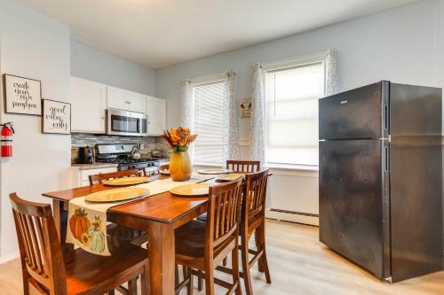 a kitchen with a table and a stainless steel refrigerator at Charming Stoughton Apartment 20 Mi to Boston in Stoughton