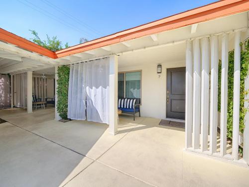 a house with a patio with surfboards on it at Little Paradise Hotel in Palm Springs
