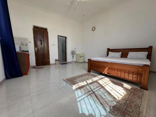 a bedroom with a bed and a rug on the floor at Michamvi Biman Apartments in Michamvi