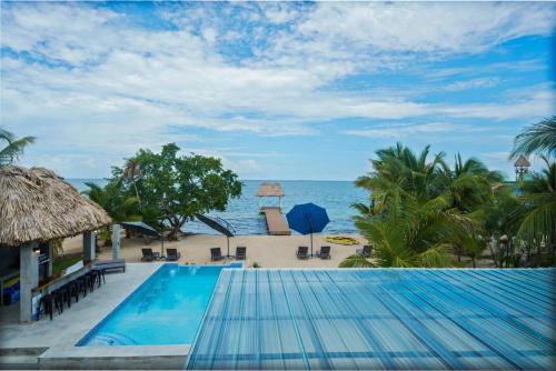 a view of the beach from a resort pool at Oceanfront 3 Bedroom - Conmigo Villas North in Maya Beach
