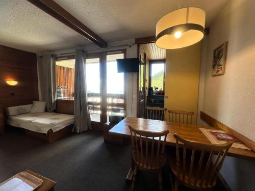 - un salon avec une table et une chambre avec un canapé dans l'établissement Residence 3000 Bail - Studio pour 4 Personnes 34, à Aime La Plagne