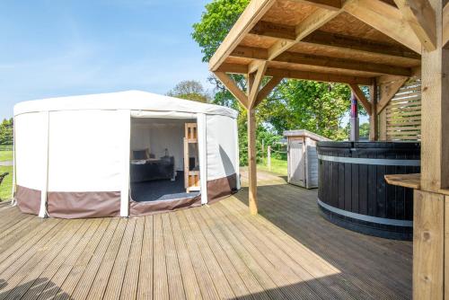 a large white tent on a wooden deck at Dukeries Retreat in Retford
