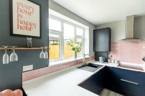 a kitchen with a sink and a happy hour sign on the wall at HIGHBANK HOUSE - Three Bed Stylish House in North Yorkshire in Harrogate