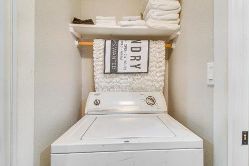 a laundry room with a washing machine and towels at Rural Spiro Getaway with Private Deck! in Pocola