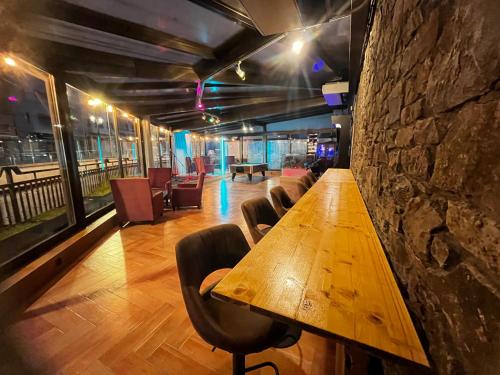 a long wooden table in a room with chairs at HMC K-ena in Andorra la Vella
