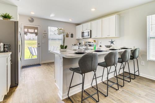 a kitchen with a counter and stools at a kitchen island at Brand-New Savannah Area Home 15 Mi to Dtwn! in Port Wentworth