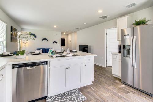 a kitchen with white cabinets and stainless steel appliances at Brand-New Savannah Area Home 15 Mi to Dtwn! in Port Wentworth