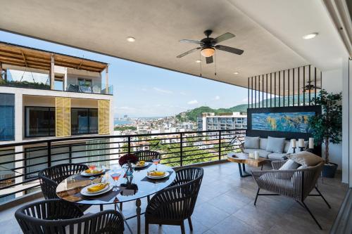 a balcony with a table and chairs and a view at Pinnacle Resorts 180 in Puerto Vallarta