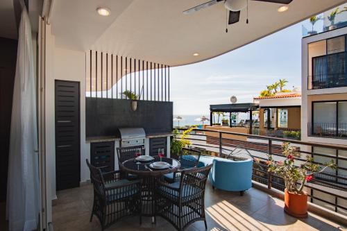 a patio with a table and chairs on a balcony at Pinnacle Resorts 180 in Puerto Vallarta