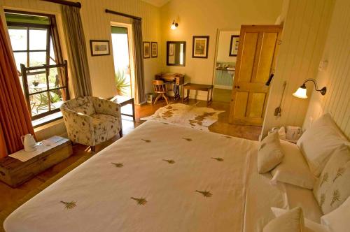 a bedroom with a large bed in a room at Three Tree Hill Lodge in Bergville