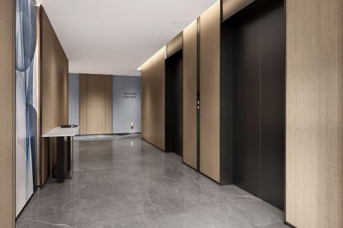 a hallway with brown walls and a hallway with a hallway at Fairfield by Marriott Changshu Hi-Tech Zone in Changshu