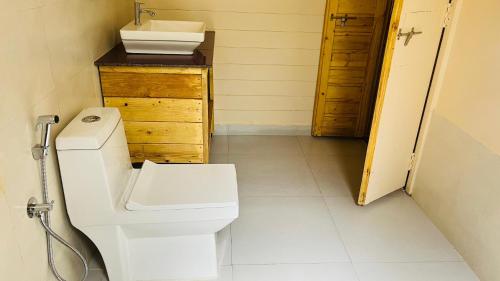 a bathroom with a toilet and a sink at The Mild Goa in Patnem