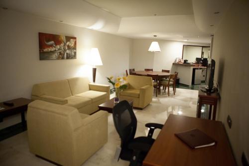 a living room with a couch and chairs and a table at EXECUTIVE SUITES VALENCIA in Valencia