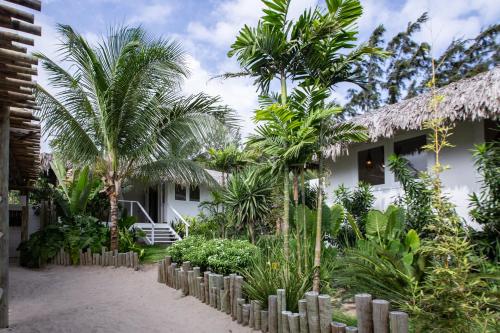 a resort with palm trees in front of a building at Preabeach Boutique Hotel & SPA in Prea