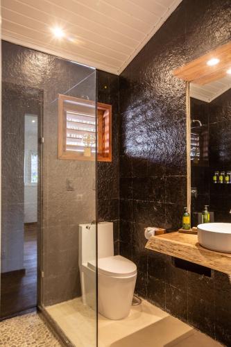 a bathroom with a toilet and a sink at Preabeach Boutique Hotel & SPA in Prea