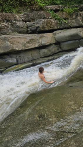 a woman is in the water in a river at Ocean Peak Home in Fajardo