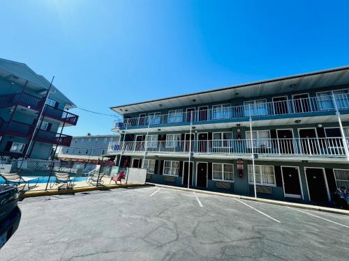 a building with a parking lot in front of it at Seagem Motel and Apartments in Seaside Heights