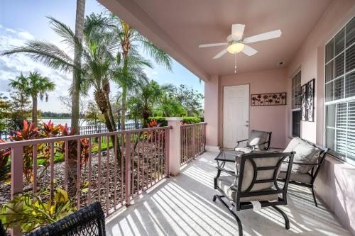 a balcony with two chairs and a ceiling fan at Vista Cay Resort by Millenium at Universal Blvd. in Orlando