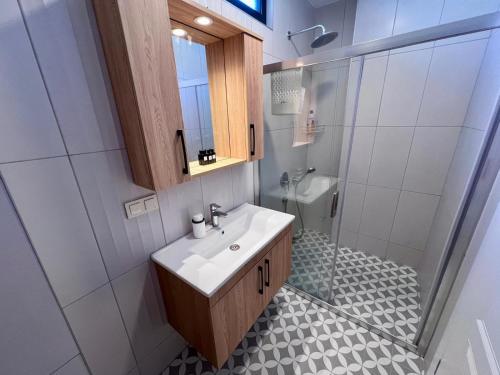 a bathroom with a sink and a shower at Göcek Villa Hayal in İnlice