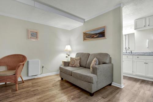 a living room with a couch and a chair at The Waterway 115 by Sea Scape Properties in Wrightsville Beach
