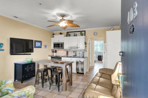 a kitchen and living room with a table and a couch at The Waterway 403 by Sea Scape Properties in Wrightsville Beach